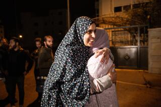JERUSALEM - NOVEMBER 24: Marah Bakr (L), Palestinian detained in Israeli prison for 8 years, is welcomed by her family after releasing to be released as part of the 4-day humanitarian pause begins for prisoner exchange between the Israeli army and Palestinian group Hamas on November 24, 2023, in Jerusalem. (Photo by Mostafa Alkharouf/Anadolu via Getty Images)