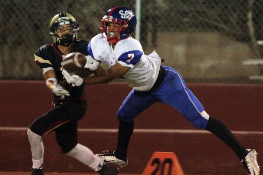 Gardena Serra's Brandon Burton, right, breaks up a pass intended for Alemany receiver Stanley Norman during a game Friday in Mission Hills, Calif.
