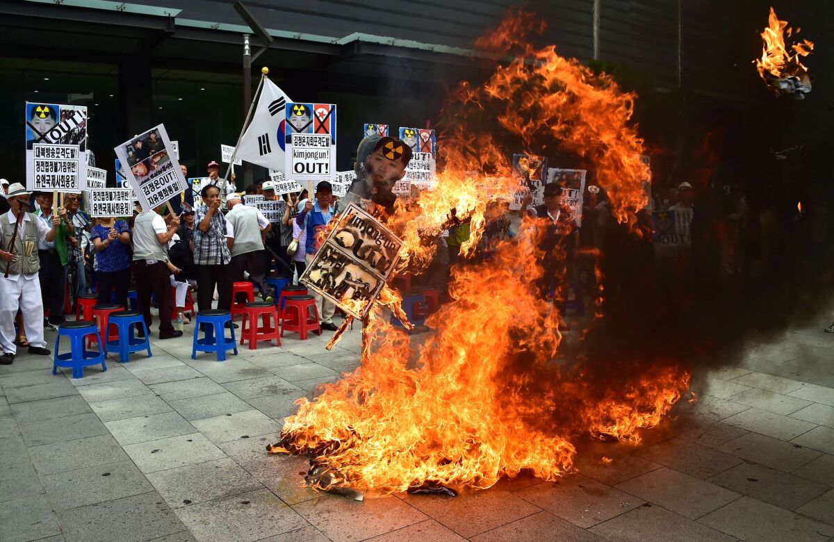 South Korean activists burn an effigy of North Korean leader Kim Jong Un at a rally in Seoul on Friday.