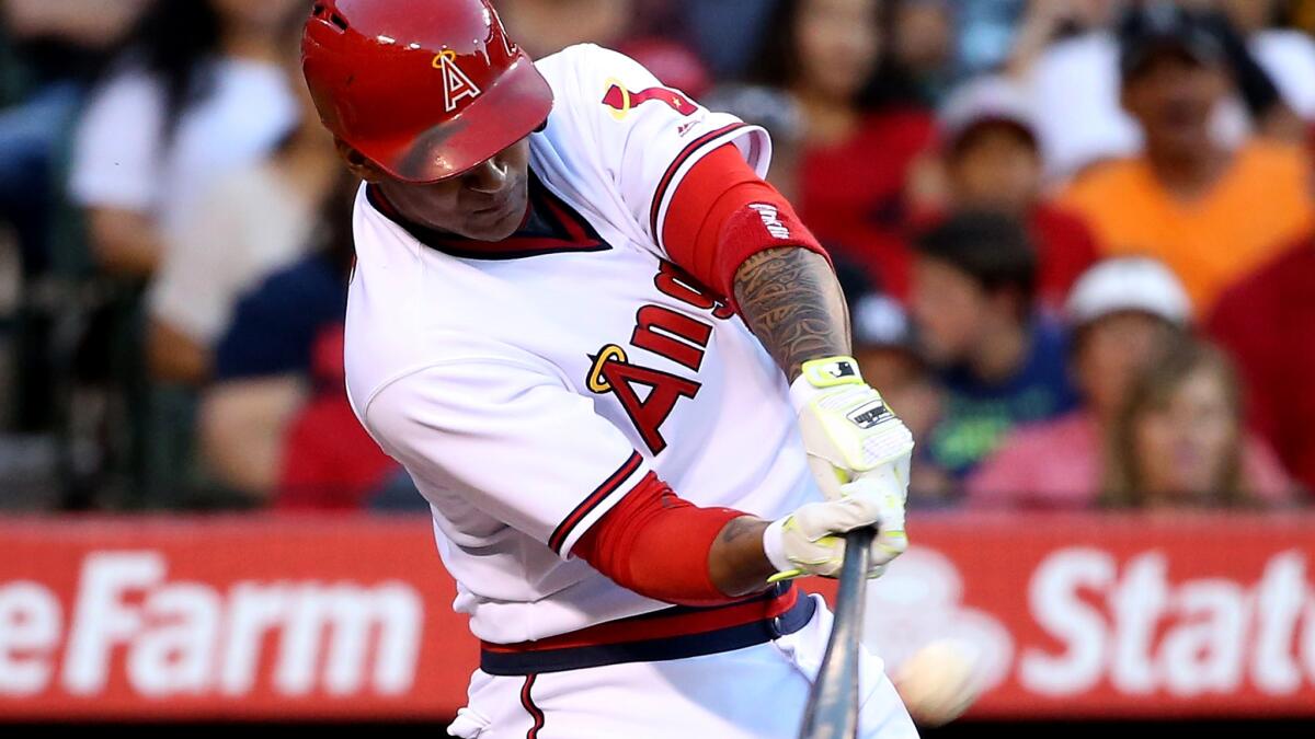 Angels first baseman Jefry Marte connects for a three-run home run against the Rangers in the first inning Wednesday night.