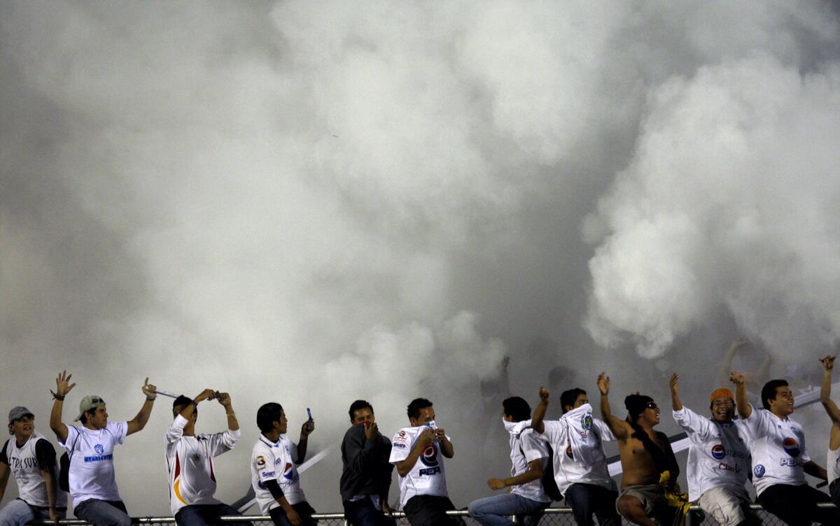 Guatemala's Comunicaciones' fans cheer prior to a CONCACAF Champions League soccer match against Honduras Real Espana in Guatemala City, Thursday, Sept. 17, 2009. (AP Photo/Moises Castillo)