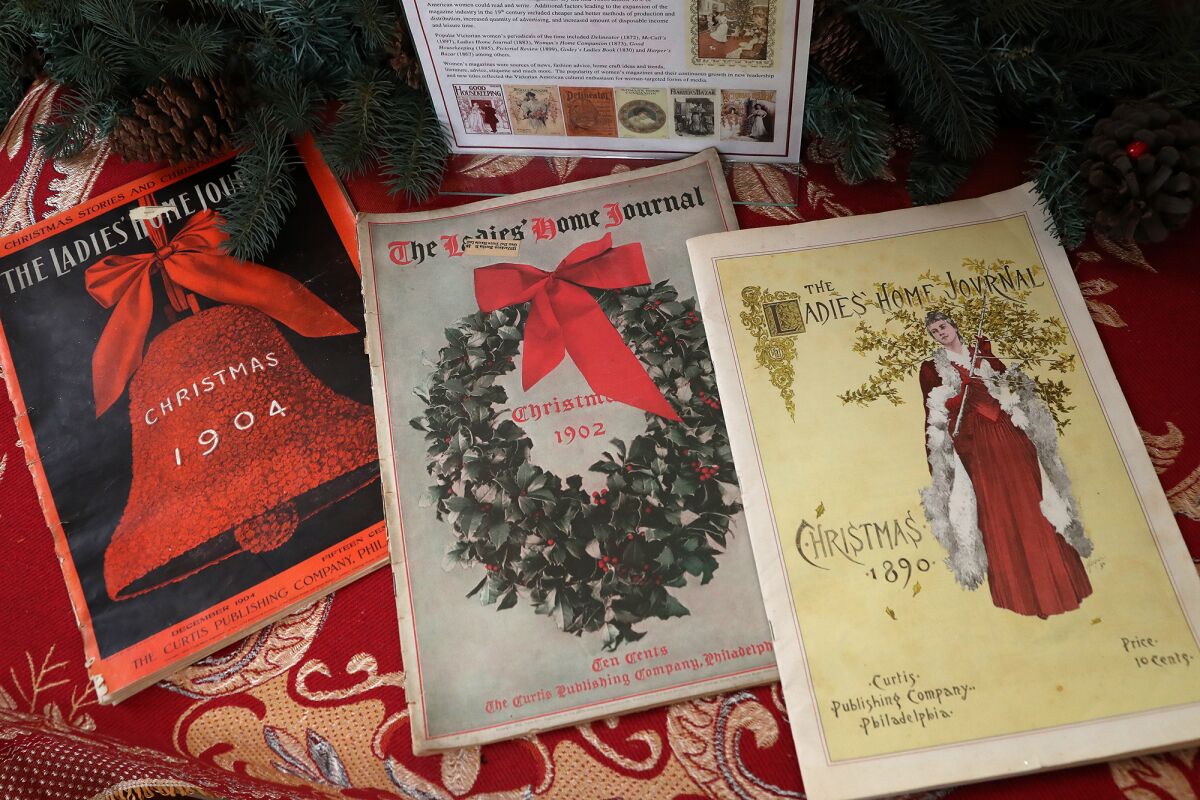 Vintage magazines from the late 1800s and early 1900s with covers celebrating Christmas.