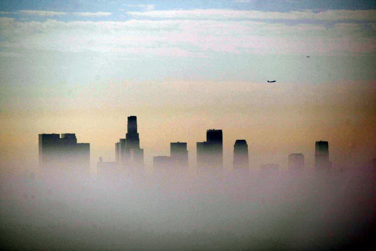 Smog obscures a city skyline.