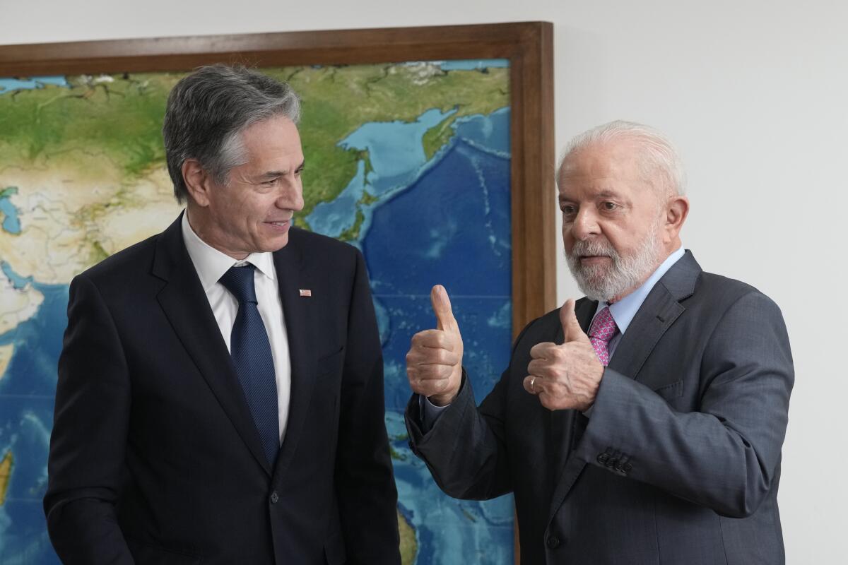 Brazil's President Luiz Inacio Lula da Silva, right, gives a thumbs up next to U.S. Secretary of State Antony Blinken.
