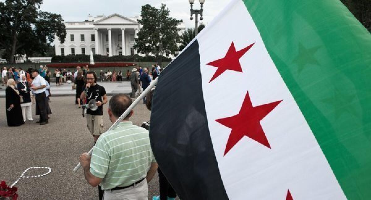 Demonstrators call on President Obama to help the uprising in Syria in a protest in front of the White House on Wednesday.