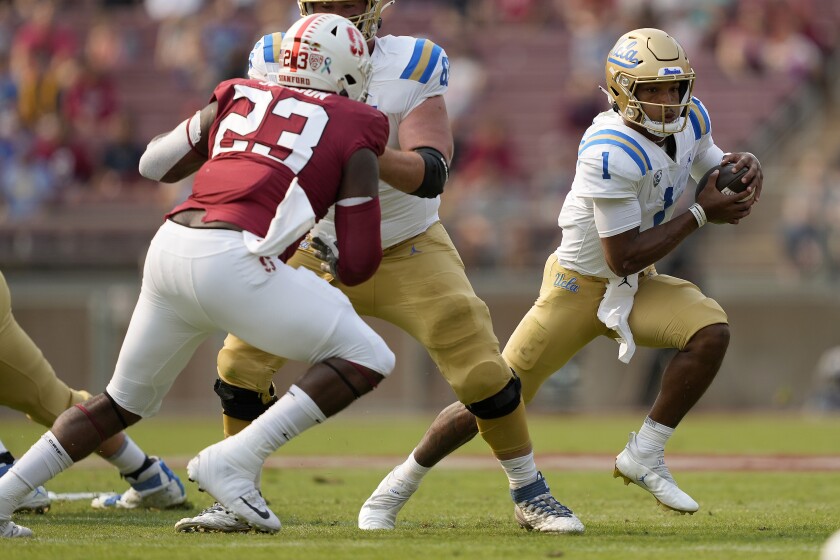 UCLA quarterback Dorian Thompson-Robinson scrambles against Stanford