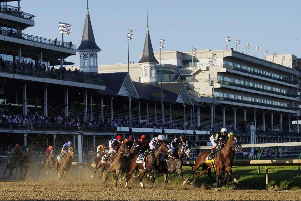 John Velazquez rides Authentic as they lead the pack into turn one in the 146th running of the Kentucky Derby.
