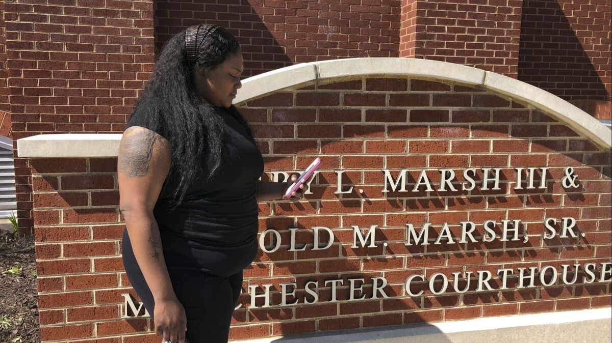 Strangé Simon, 25, stands outside a courthouse on April 16, 2019 in Richmond, Va. Simon attended a recent hearing in her marijuana possession case. Simon said receiving text reminders from the public defender's office stopped her from showing up for court on the wrong day.