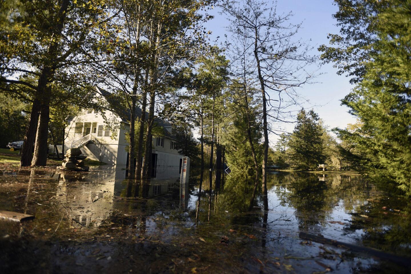 Floodwaters begin to come into the yards of homes along Wido Moore Drive on Oct. 11, 2016, in Currie, North Carolina.