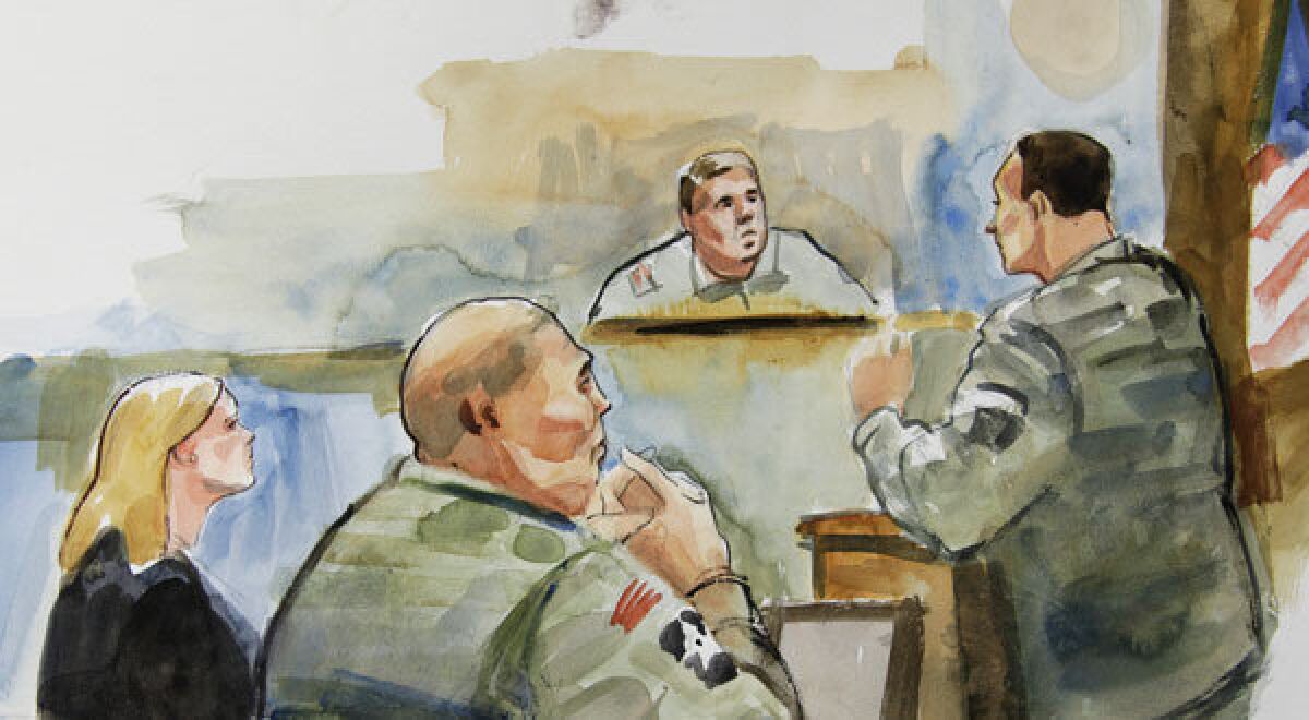 In this courtroom sketch, U.S. Army Staff Sgt. Robert Bales, second from left, sits next to Emma Scanlan, left, one of his civilian attorneys.