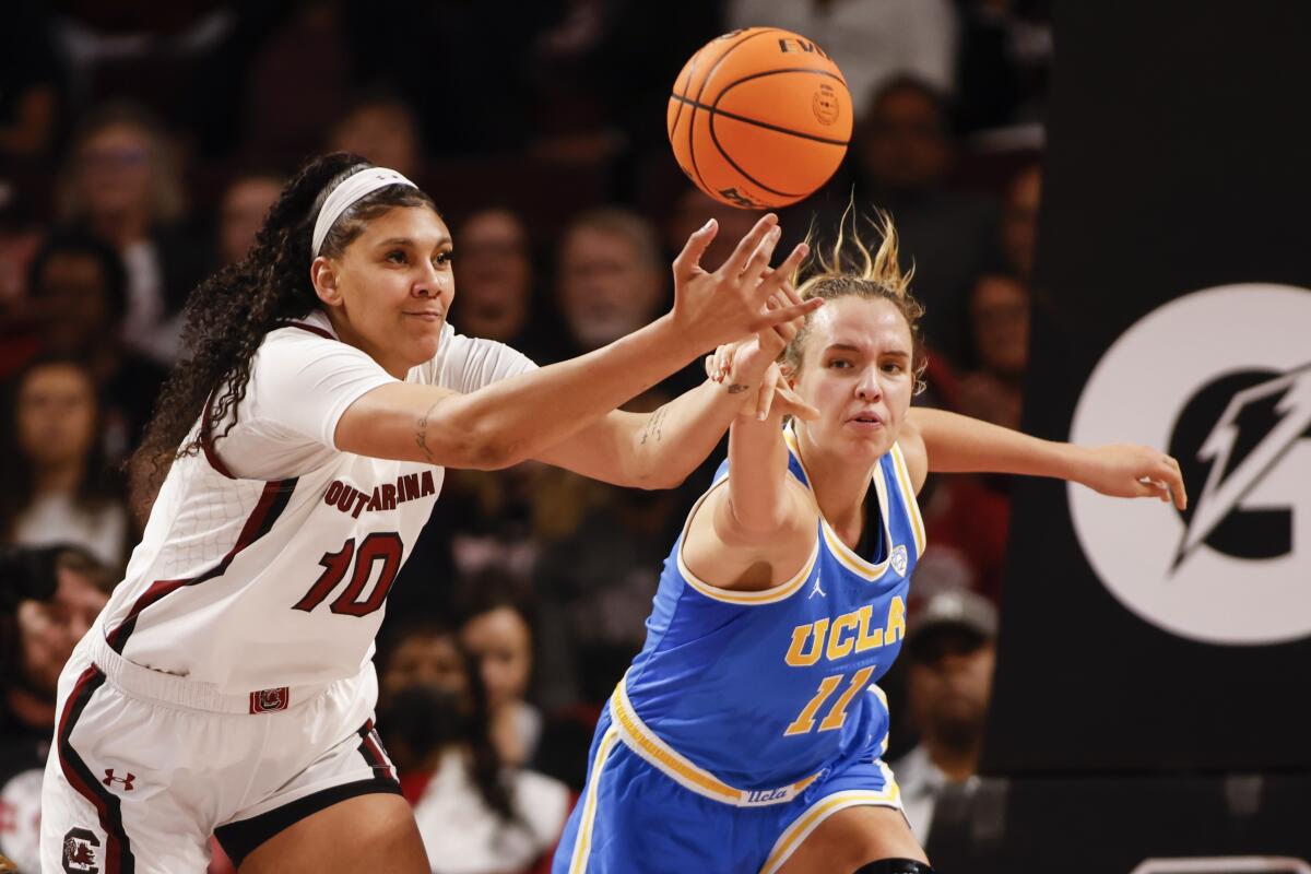 South Carolina center Kamilla Cardoso, left, battles UCLA forward Emily Bessoir for a rebound.