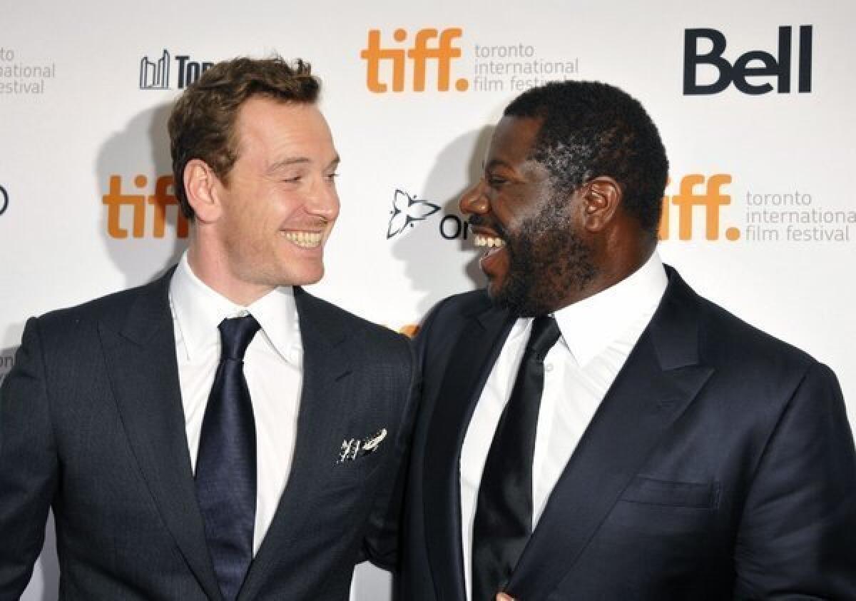 Michael Fassbender is all smiles at the Toronto Film Festival with "12 Years a Slave" director Steve McQueen.