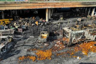 Los Angeles, CA, Monday, November 13, 2023 - Produce lays strewn across the pavement days after a large pallet fire burned below, destroying numerous businesses housed below the I-10. (Robert Gauthier/Los Angeles Times)