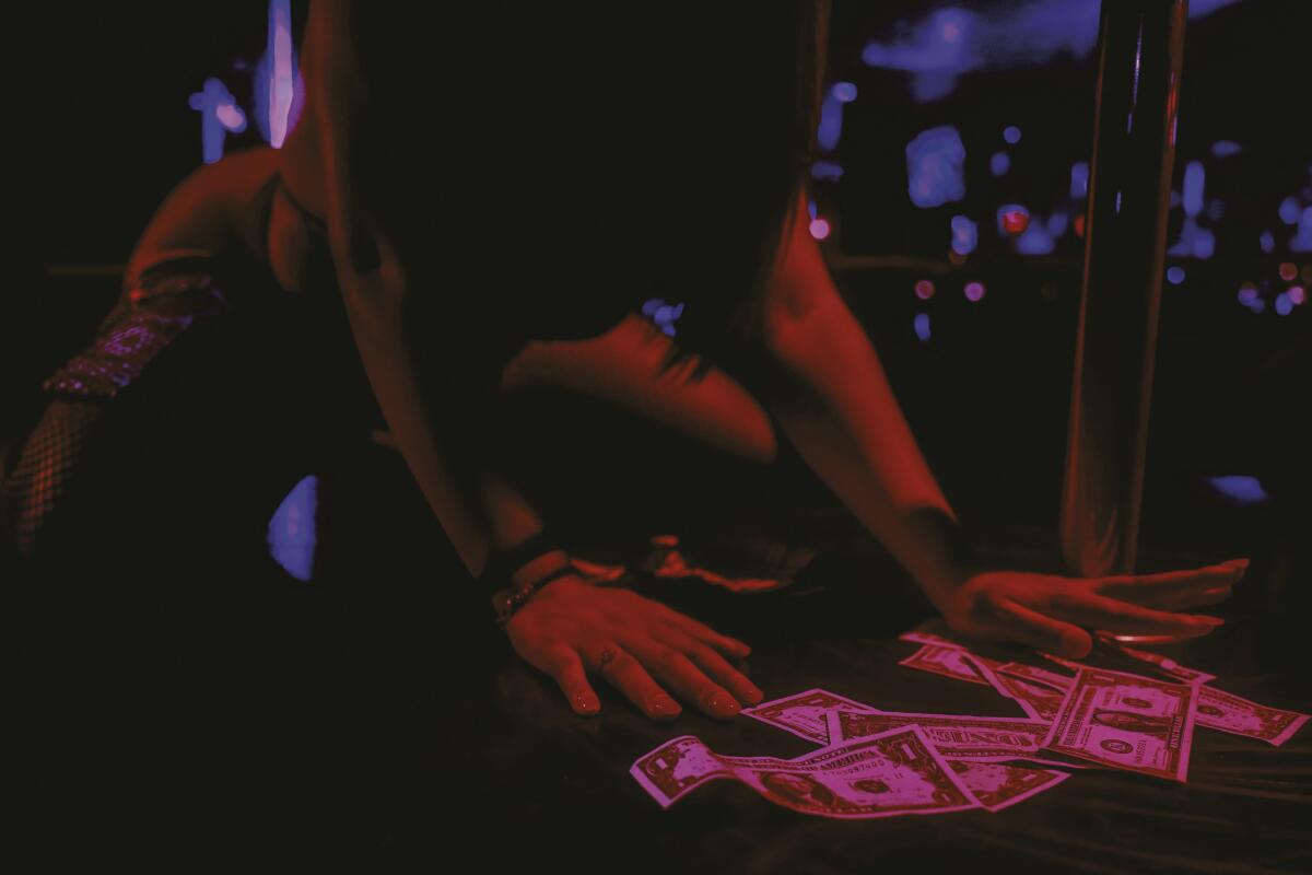 photo of someone picking cash up from the floor 