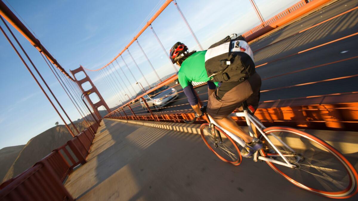 A solo cyclist crossing the Golden Gate Bridge at sunset on the commute home to the Marin near San Francisco, California. (Ty Milford / Getty Images/Aurora Open)
