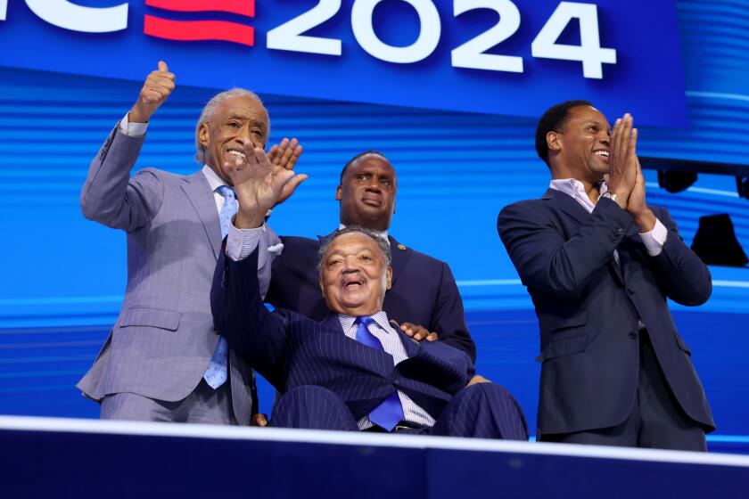 DNC CHICAGO, IL AUGUST 19, 2024 - The Rev. Jesse Jackson (front center) waves as he appears on stage during the 2024 Democratic National Convention at United Center in Chicago on Monday, August 19, 2024 in Chicago, IL. (Robert Gauthier/Los Angeles Times)