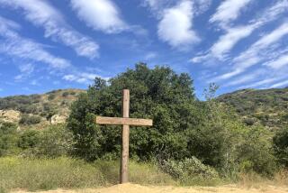 A view of the 14-foot wooden cross at the Santiago Retreat Center before it was cut down. The cross was recently been dedicated during a retreat in mid June.