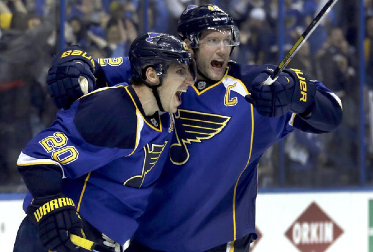 Blues left wing Alexander Steen (20) celebrates with center David Backes after scoring the game-winning goal against the Blackhawks in the third overtime Thursday night in St. Louis.