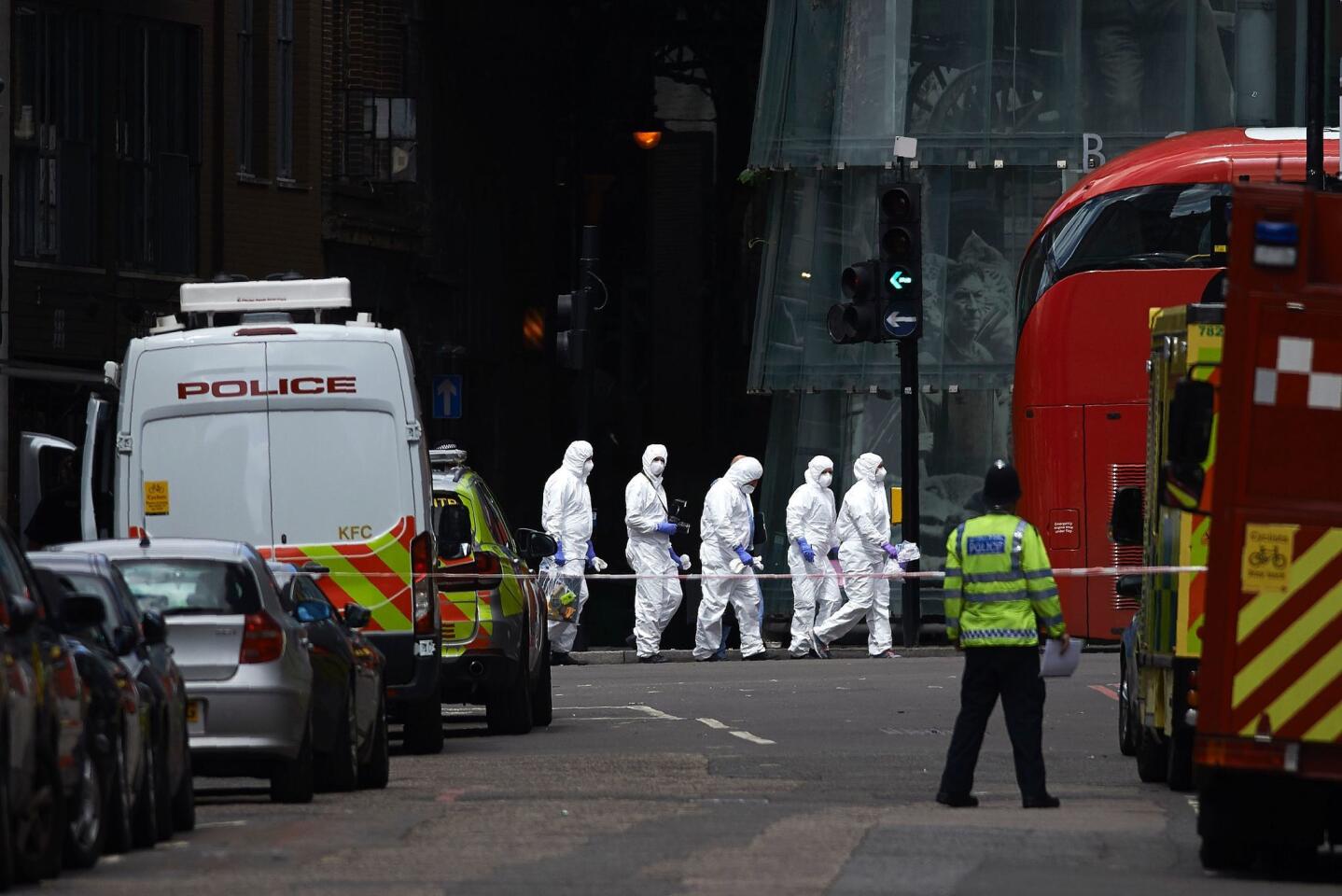 Police forensic officers work near Borough Market in London on June 4, 2017, as police continue their investigations following the June 3 terror attack.