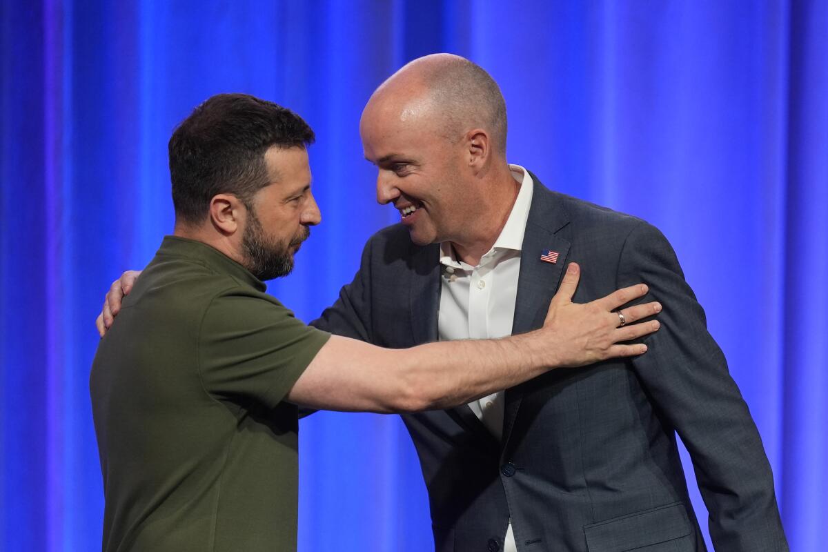 Utah Gov. Spencer Cox, right, greets Ukraine's President Volodymyr Zelensky, left