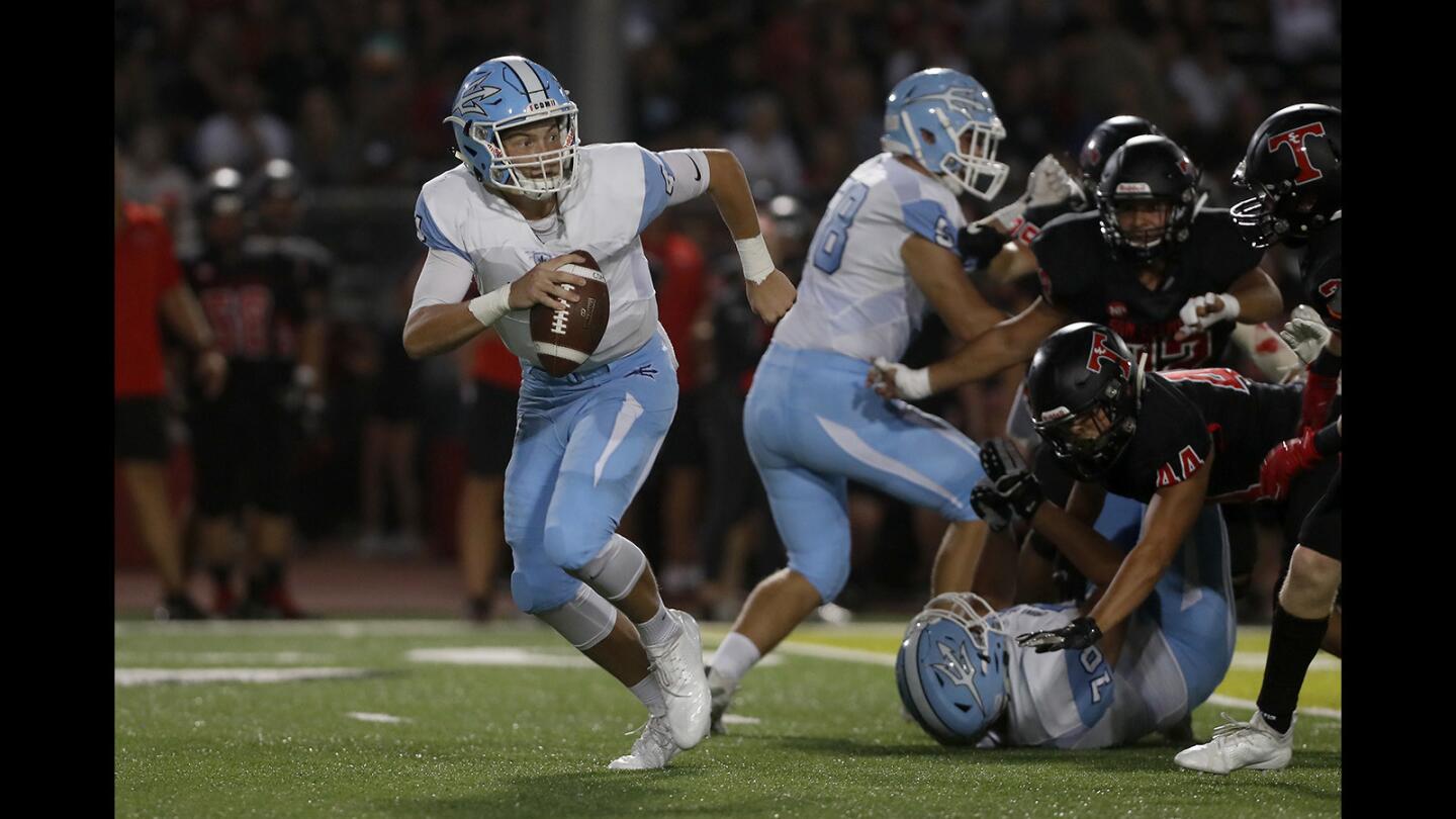 Corona del Mar High quarterback Ethan Garbers scrambles out of the pocket against San Clemente during the first half in a nonleague game at San Clemente High School on Friday, Sept. 14.