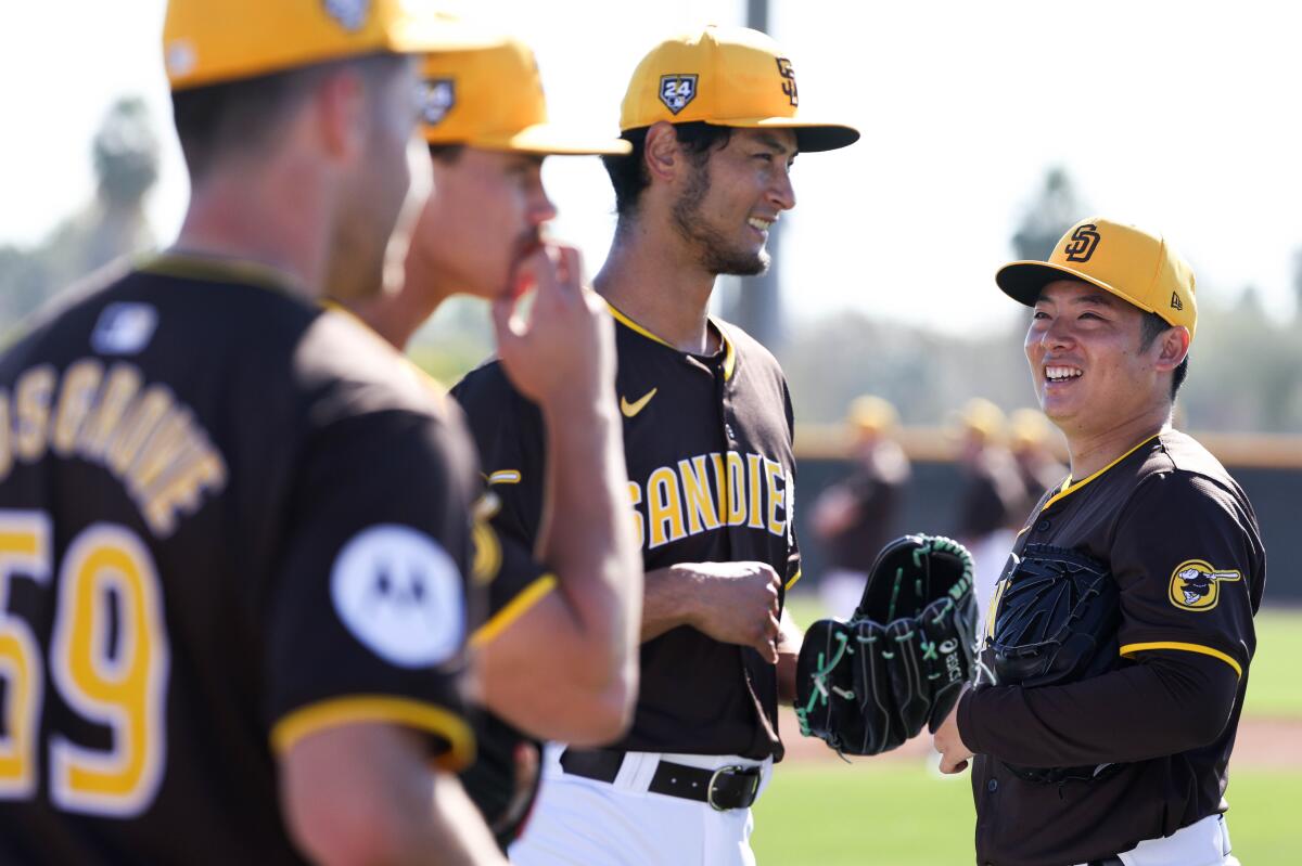 Yu Darvish and Yuki Matsui, right, laugh together during a spring training workout