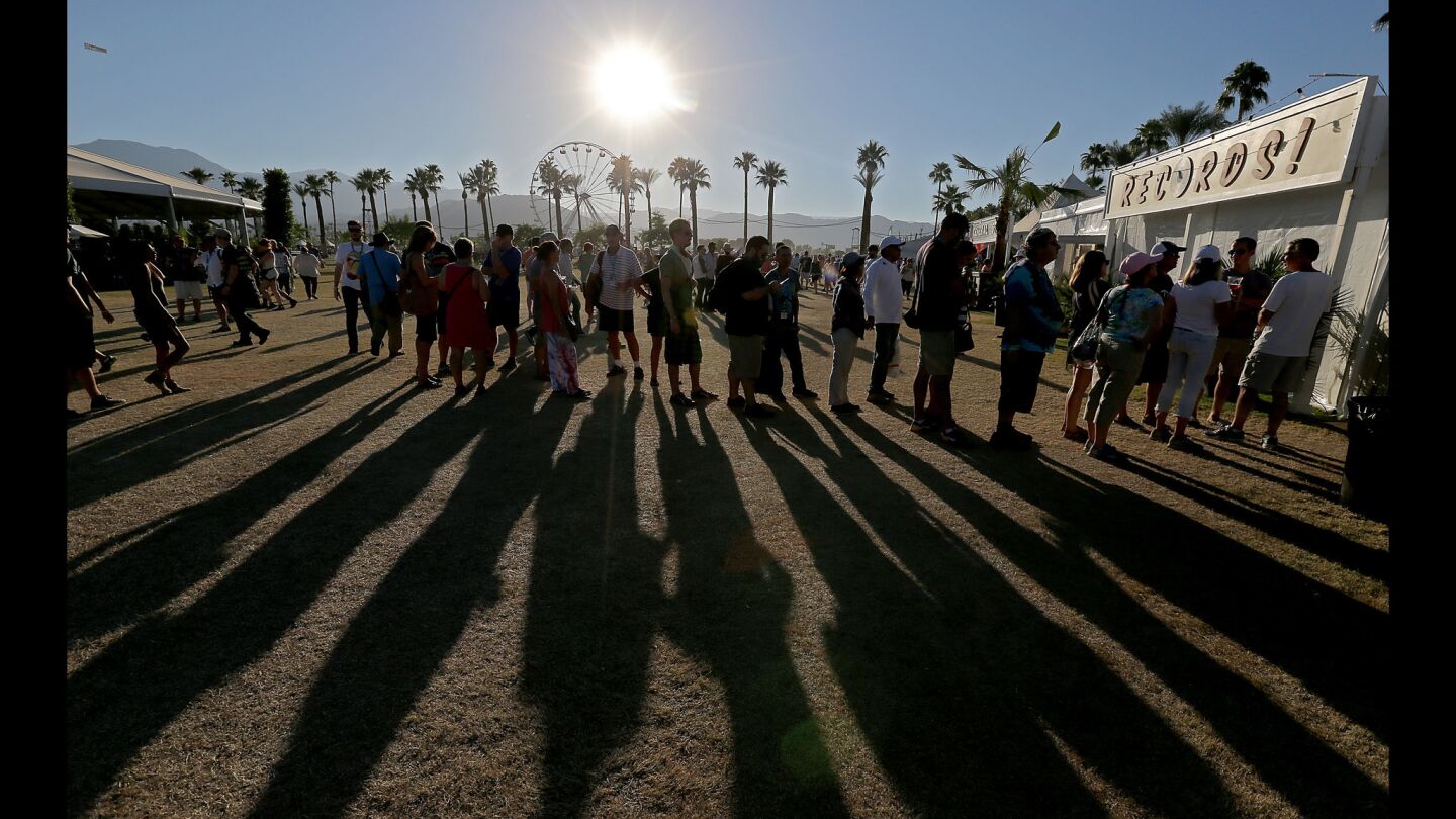 Music fans wait in line to check out the vinyl and cassette tapes at a record store on the Empire Polo Grounds during Weekend 2 of Desert Trip in Indio.