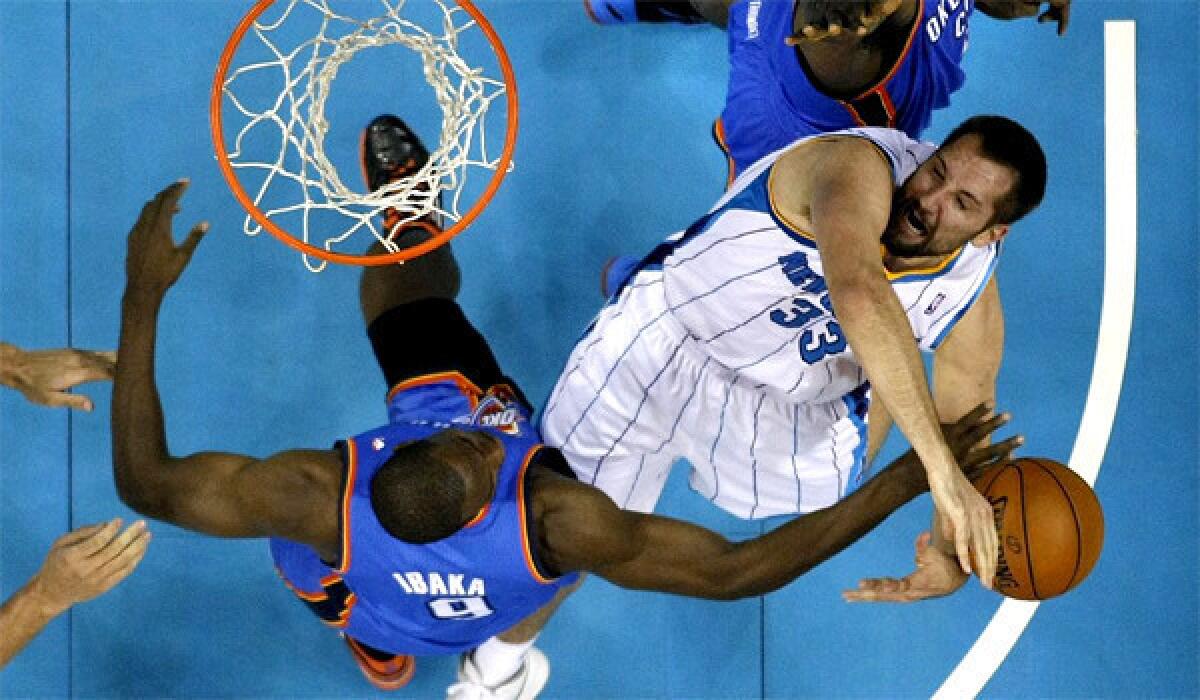 New Orleans' Ryan Anderson, right, has his shot bocked by Serge Ibaka in a game against Oklahoma City on Friday.