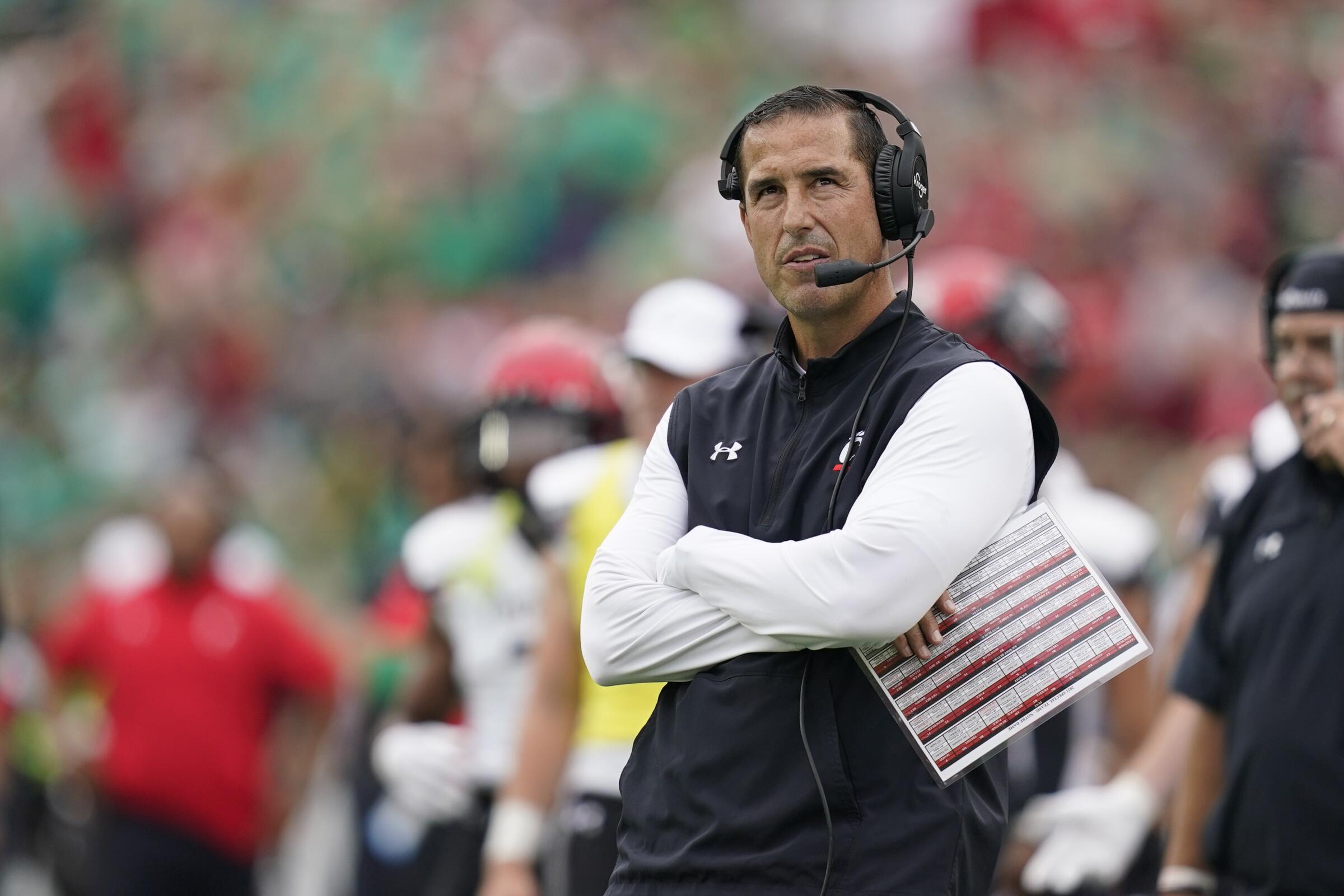 Cincinnati coach Luke Fickell watches a replay during the first half.