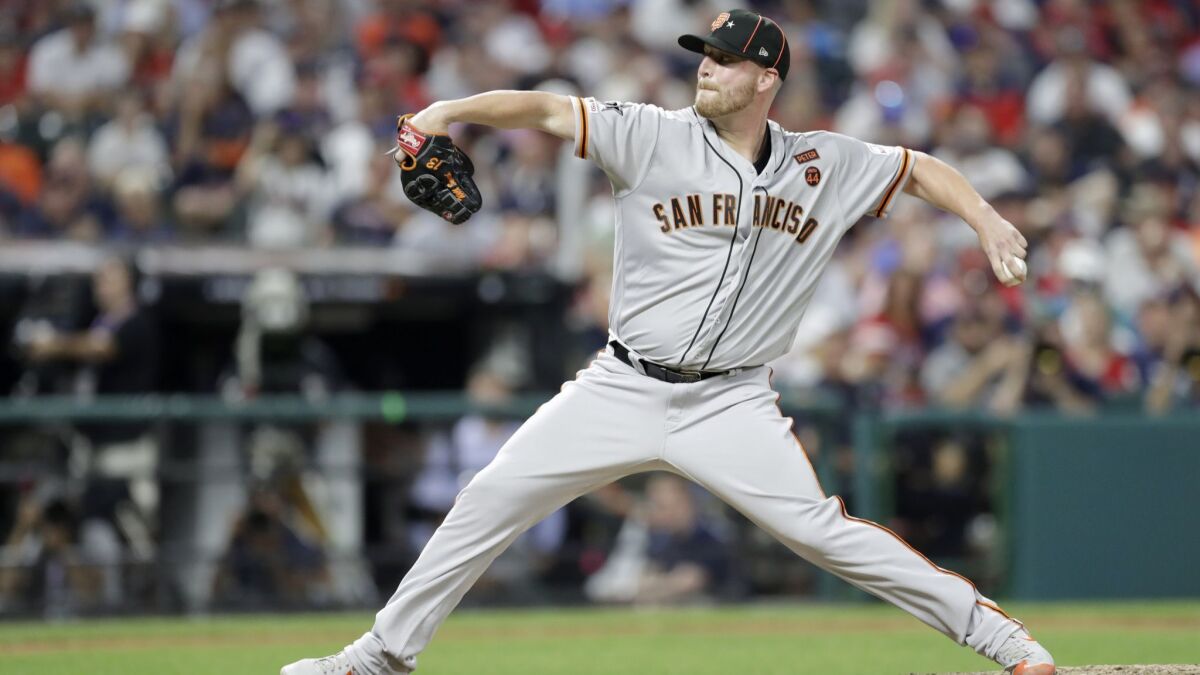 San Francisco Giants' Will Smith throws during the seventh inning of the MLB All-Star Game on Tuesday in Cleveland.