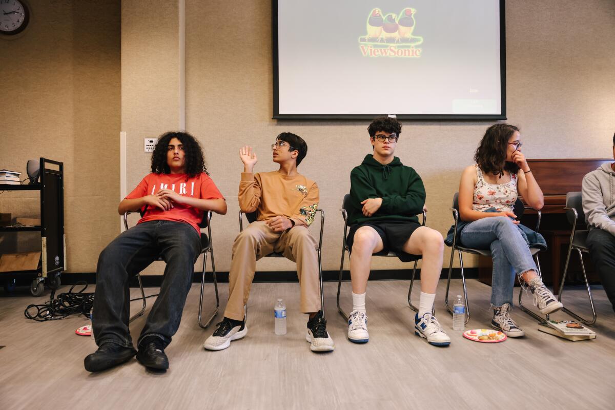 A group of teens sit during a presentation by the Teens Leading Change initiative at the Palms-Rancho Park Branch Library.