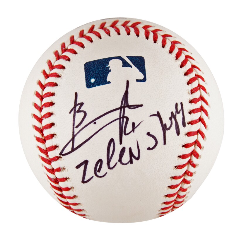 FILE — This image provided by RR Auction shows a baseball signed by Ukrainian President Volodymyr Zelenskyy. The baseball sold at auction for more than $50,000, a portion of which will go toward providing humanitarian aid to Ukrainians displaced by the nation's war with Russia, auctioneer RR Auction of Boston said Thursday, May 12, 2022. The winning bid for the Rawlings Major League baseball in the auction that closed Wednesday, May 11, 2022, was more than three times what is was expected to sell for. (RR Auction via AP, File)