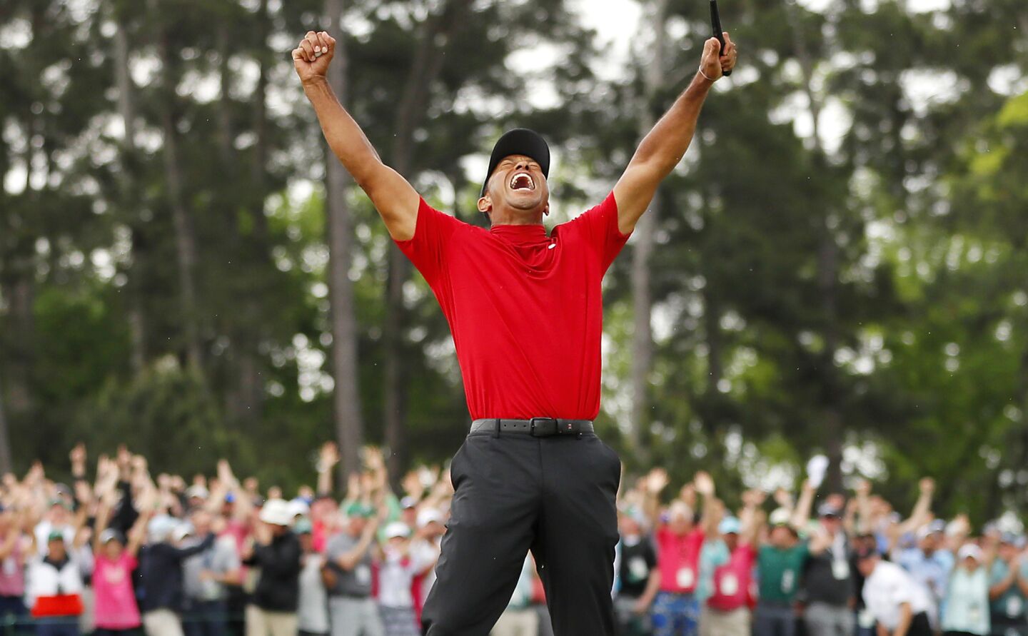 Tiger Woods celebrates after sinking his putt to win during the final round of the Masters at Augusta National Golf Club on April 14 in Augusta, Ga.