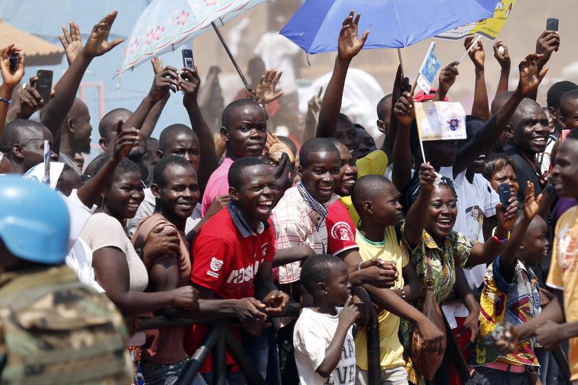 Crowds cheer as Pope Francis arrives in Bangui, Central African Republic.