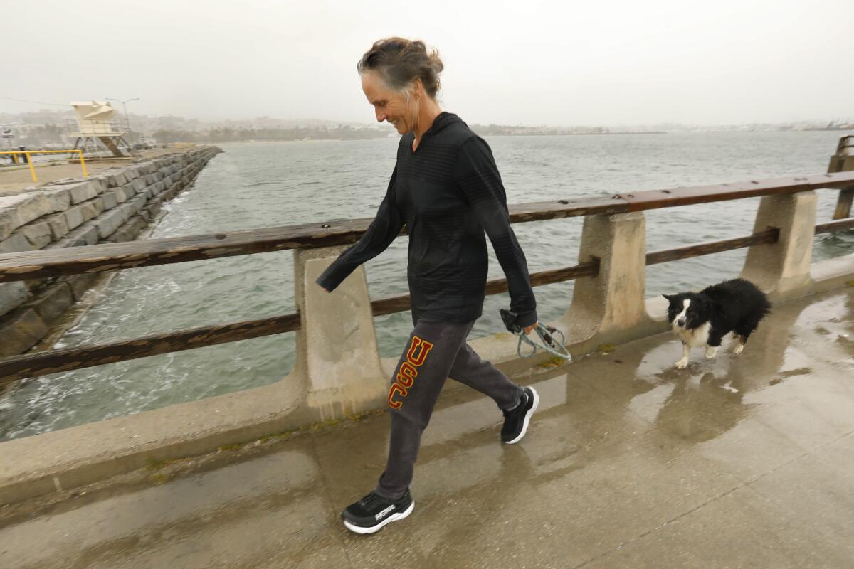 Shana Jordan takes her dog Ollie for a walk at Cabrillo Beach