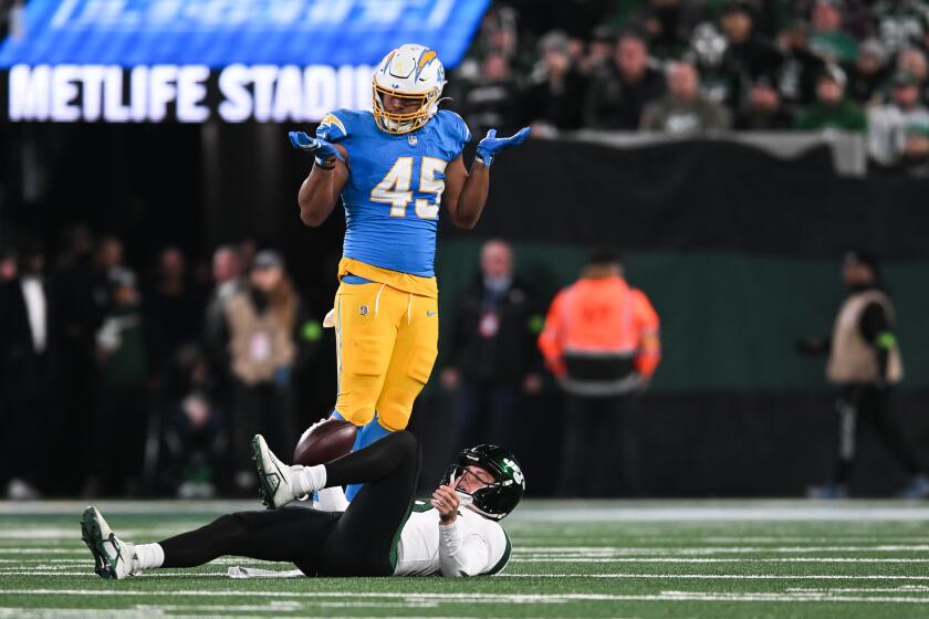 EAST RUTHERFORD, NJ - NOVEMBER 06: Tuli Tuipulotu #45 of the Los Angeles Chargers reacts after sacking Zach Wilson #2 of the New York Jets during the first half at MetLife Stadium on November 6, 2023 in East Rutherford, New Jersey. (Photo by Kathryn Riley/Getty Images)