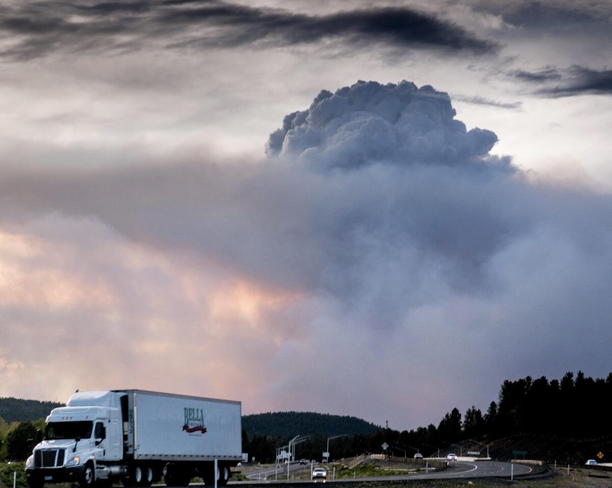 Smoke clouds cover the sky as the Slide fire rages south of Flagstaff, Ariz., on Friday.