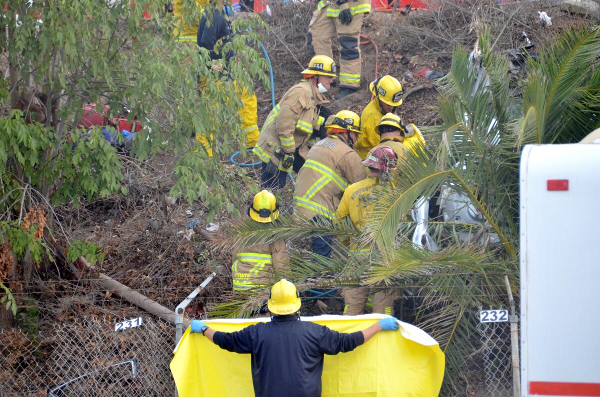 The man injured in the solo crash on Pacific Coast Highway in Newport Beach Monday evening is rescued by paramedics.