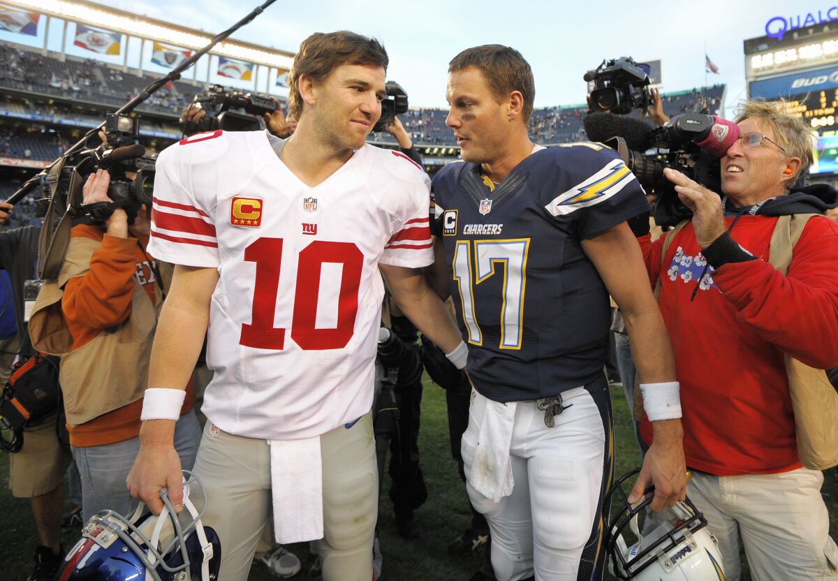Eli Manning, left,  and Philip Rivers were traded for each other after the 2004 draft.
