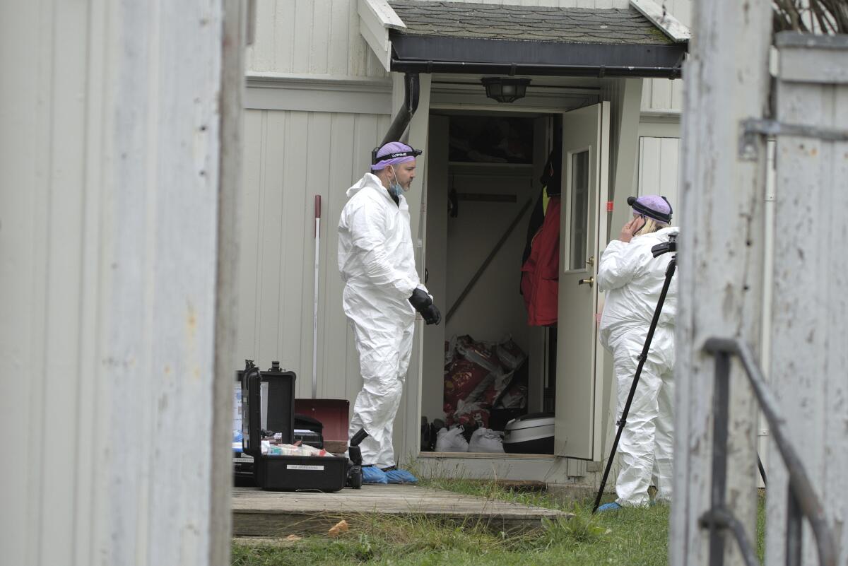 Technicians from the police investigate the apartment of the man who killed five people in a bow and arrow attack.