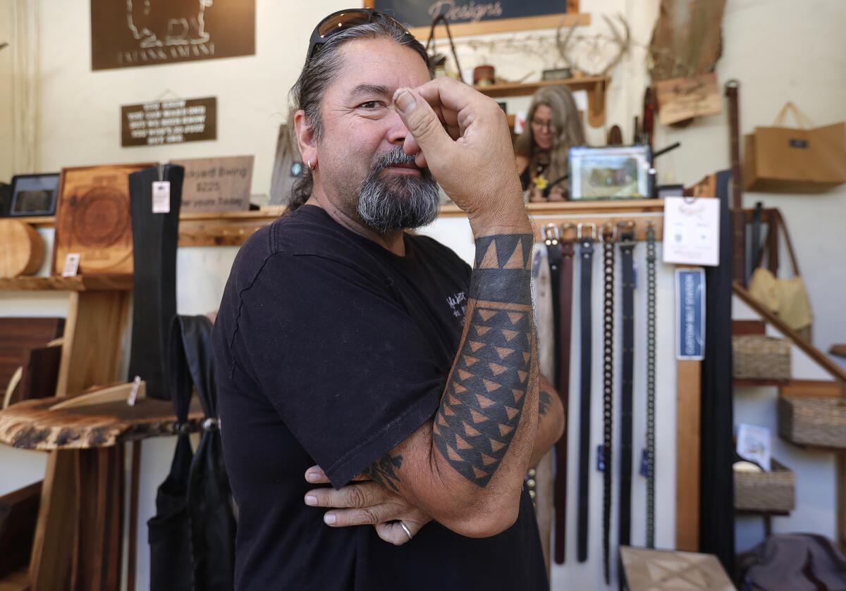 Sawdust leather artist Andrew Soliz shows his Hawaiian-style tattoo art.