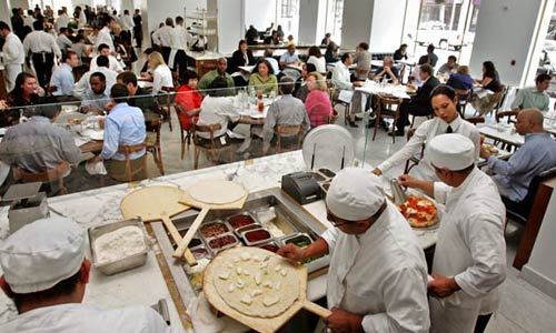 Pizzas are made for the lunch crowd at Bottega Louie in downtown Los Angeles. The kitchen gets the food out fast, which is why the Italian restaurant can feed hundreds of diners on a weekend night.