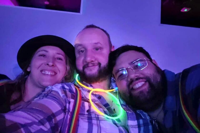 James Slaugh, center, with his sister Charlene Slaugh, left, and his boyfriend Jancarlos Dell Valle.