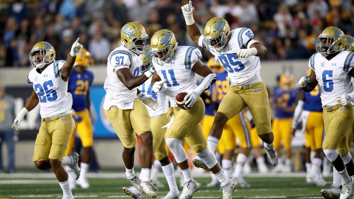 UCLA's Keisean Lucier-South (11) is congratulated by teammates after he intercepted a pass against California at California Memorial Stadium on Saturday in Berkeley.