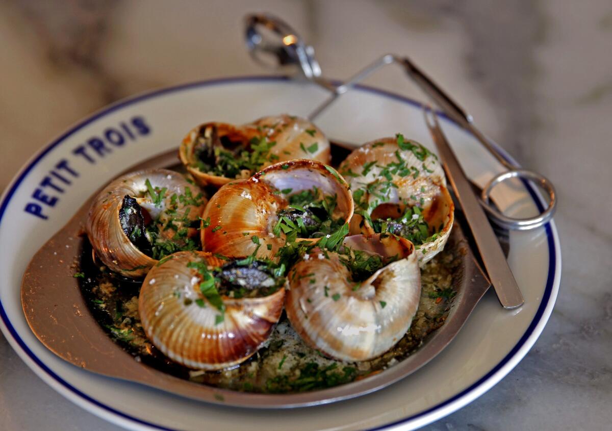 A detail of burgundy escargots at Petit Trois, a tiny, no reservations, Belle Epoque-looking bistro from Chef Ludovic Lefebvre of Trois Mec next door, Friday, Sept. 25, 2014. (Allen J. Schaben/Los Angeles Times)