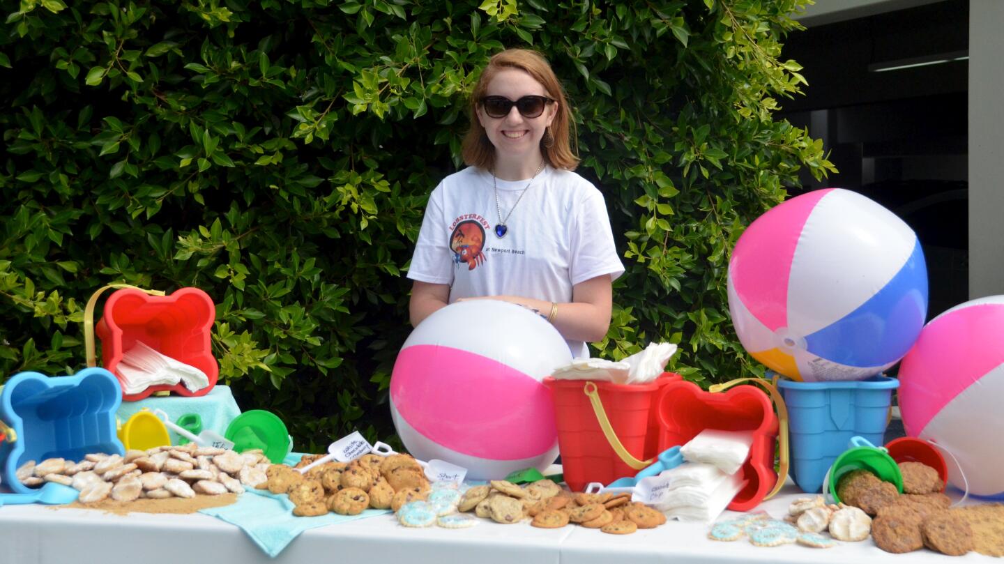 Olivia Mendel supervises the cookie table during Lobsterfest on Sunday at the Newport Beach Civic Center.
