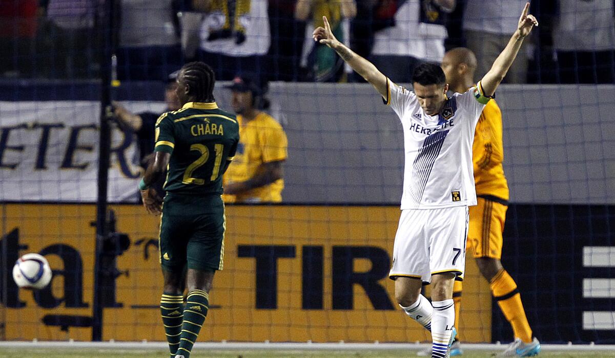 Los Angeles Galaxy forward Robbie Keane reacts to scoring on a penalty kick past Portland Timbers goalkeeper Adam Kwarasey, right, as midfielder Diego Chara, left, looks on during the first half on June 24. Galaxy won, 5-0.