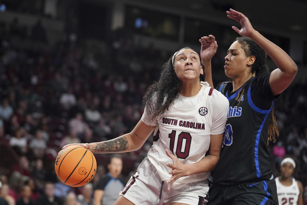 South Carolina center Kamilla Cardoso (10) drives to the hoop against Memphis center Jada Wright, right, during the first half of an NCAA college basketball game Saturday, Dec. 3, 2022, in Columbia, S.C. South Carolina won 79-54.(AP Photo/Sean Rayford)