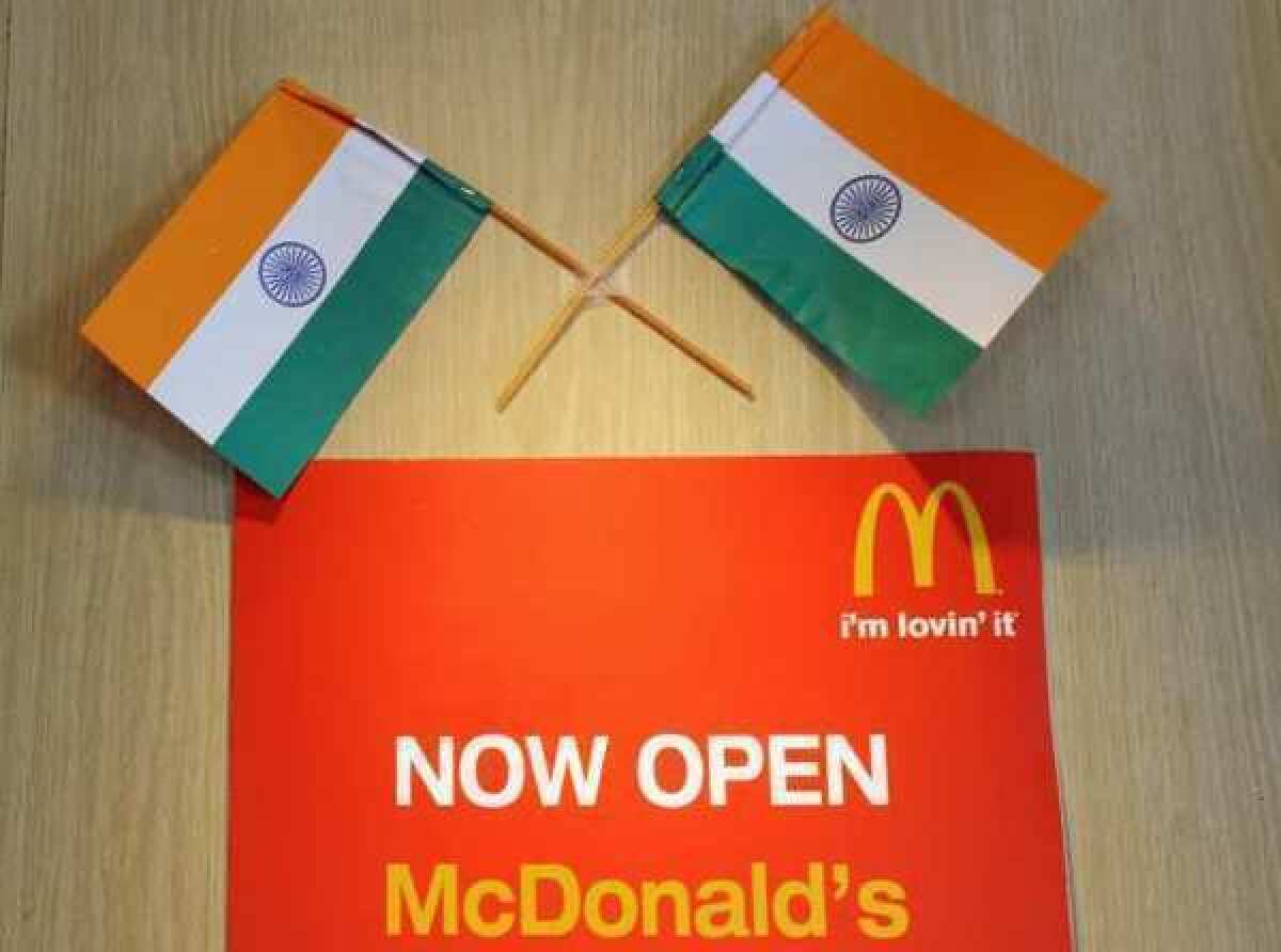 Two Indian flags adorn a sign at a local McDonalds chain restaurant in New Delhi. The fast food giant will open two vegetarian branches in the country.