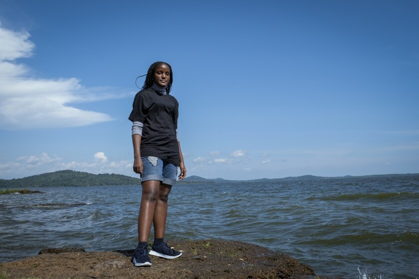 Ugandan climate activist Vanessa Nakate poses for a photograph on the shore of Lake Victoria on the outskirts of Kampala, Uganda Monday, Dec. 6, 2021. In an interview with The Associated Press, Nakate reflected on the whirlwind of the past year, including her disappointment in the outcome of the U.N. climate talks in Scotland, and what she and other young activists plan for the year to come. (AP Photo/Hajarah Nalwadda)